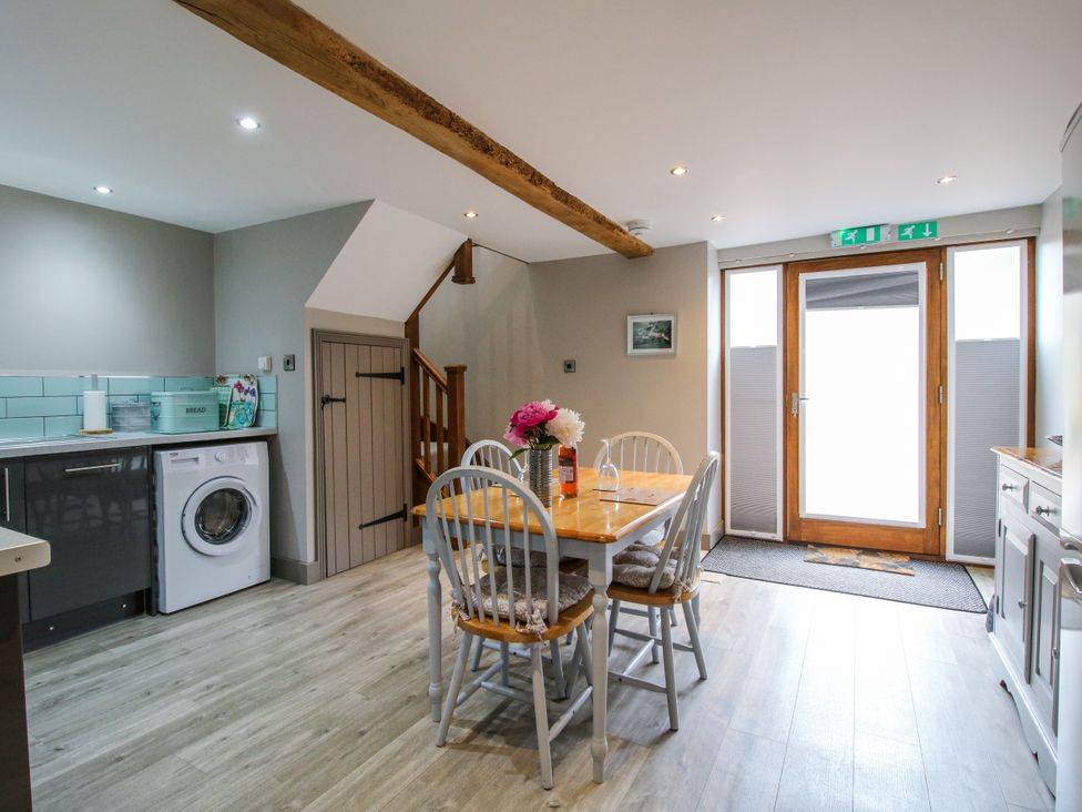 A kitchen with a table and chairs at The Hay Loft in Craven Arms