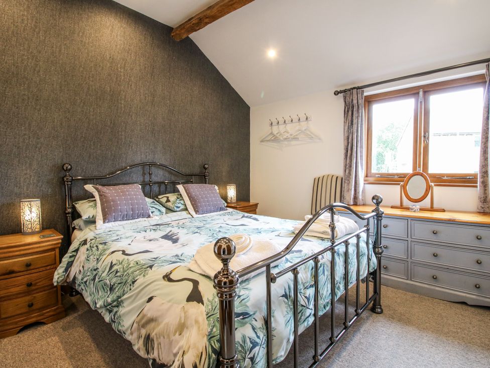 A bedroom with a bed and bedside table at The Hay Loft in Craven Arms