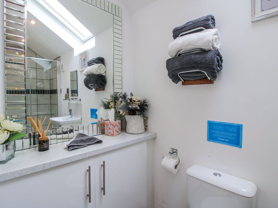 A bathroom with a toilet and sink at The Hay Loft in Craven Arms