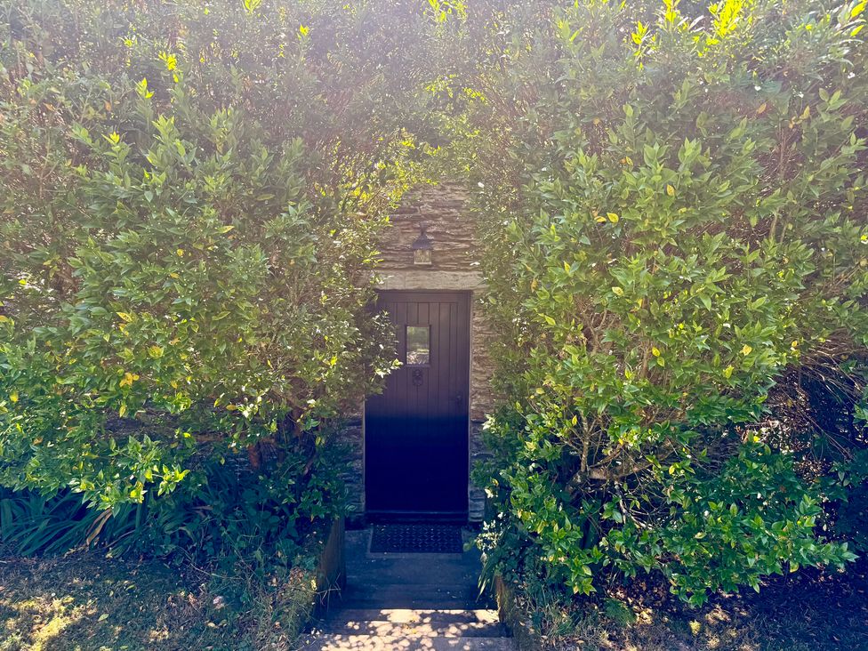 A door framed by plants at Meadow Cottage in Golant, near Fowey