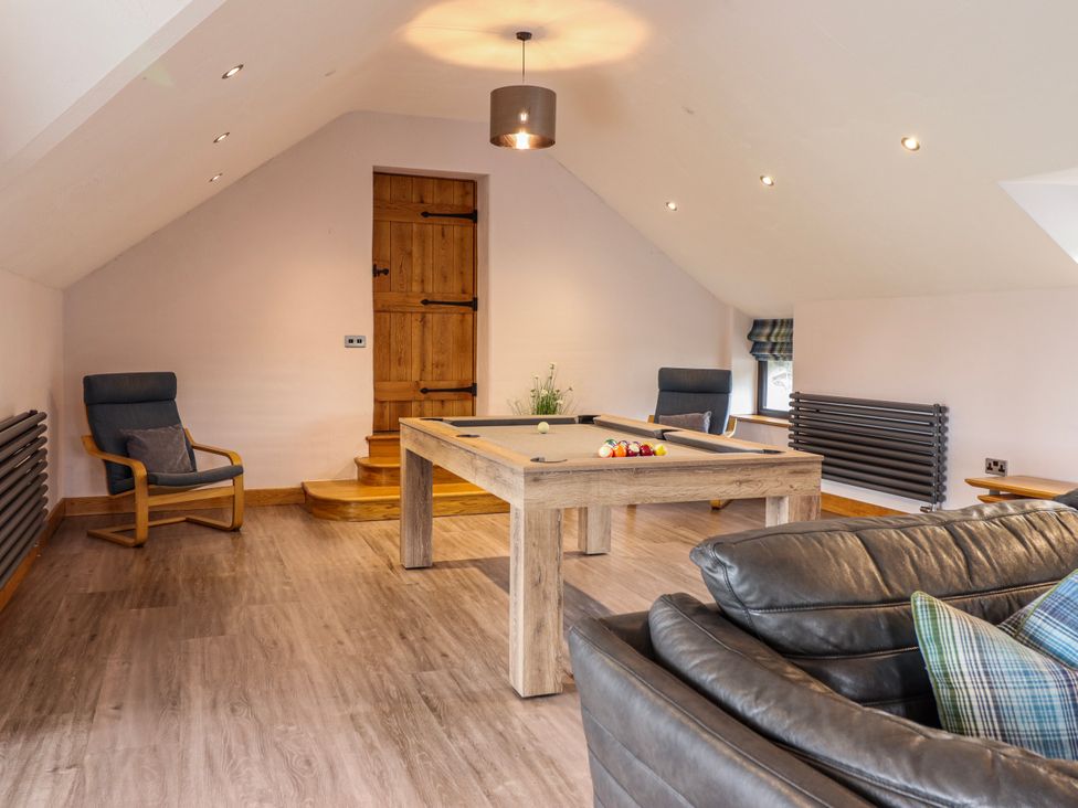 A snug with a pool table and seating area at Granar Llangwm near Bala