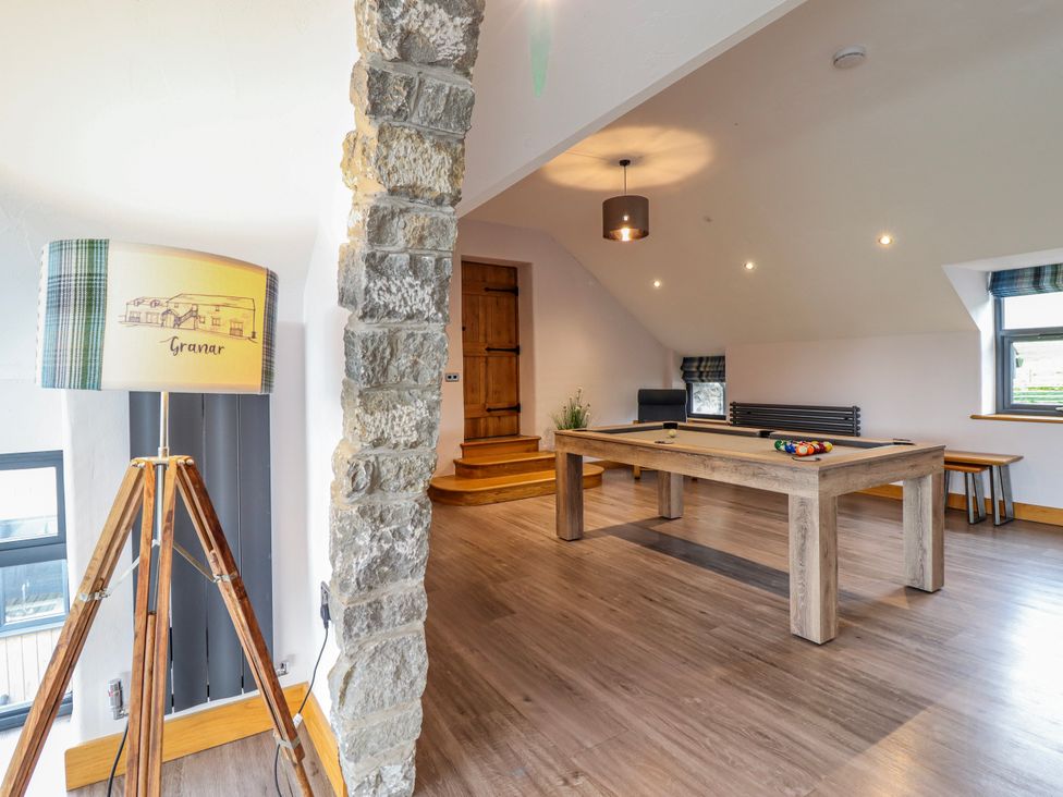 A game room with a pool table and lamp at Granar in Llangwm near Bala