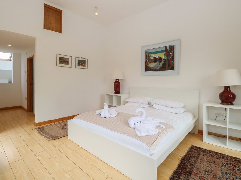 A bedroom with a bed and nightstands at Frater House Denton near Harleston