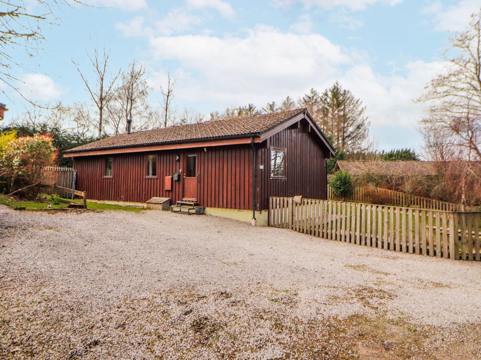 A wooden house with a gravel front yard at 26 Dukes Meadow in Greystoke near Penrith