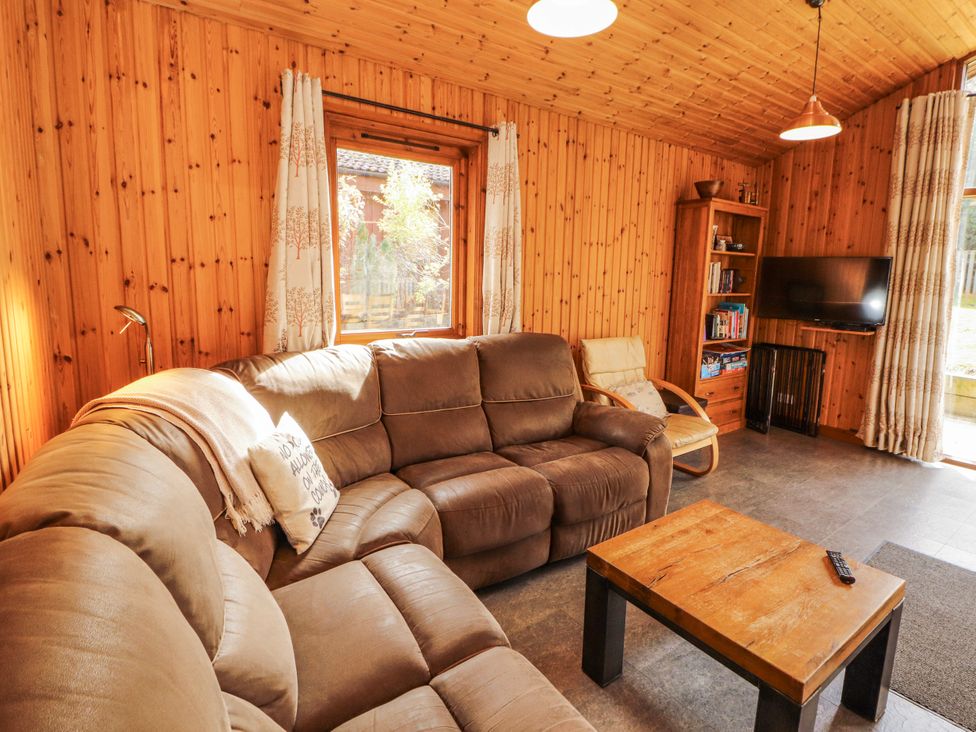 A living room with a sofa and television at 26 Dukes Meadow in Greystoke near Penrith