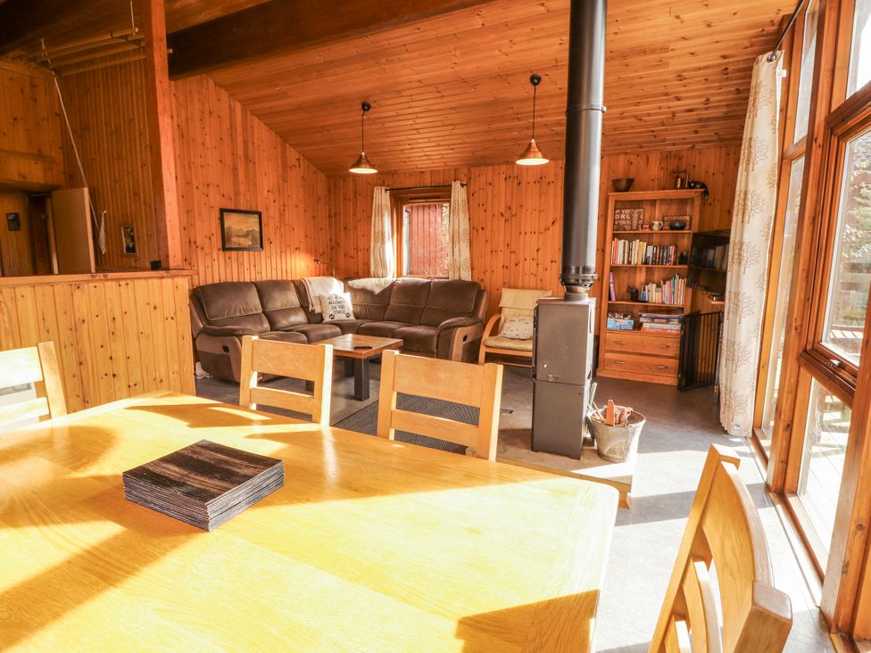 A living room with a sofa and dining area at 26 Dukes Meadow Greystoke near Penrith