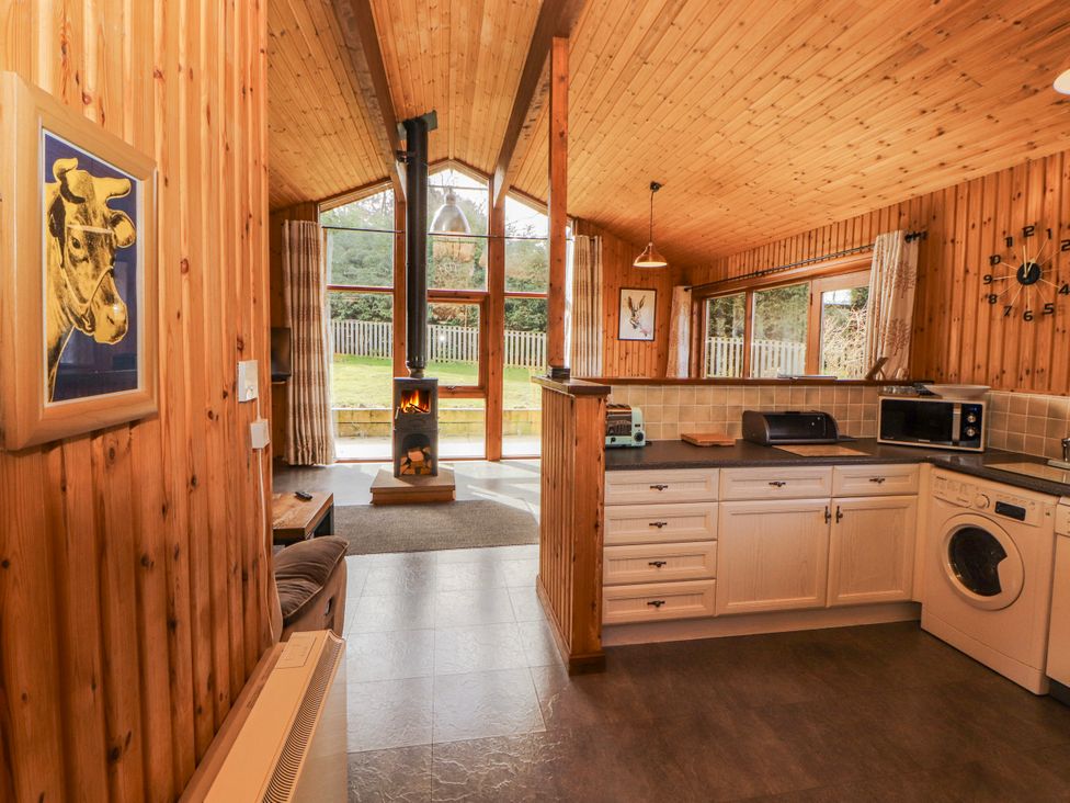 A kitchen with a stove and washing machine at 26 Dukes Meadow Greystoke near Penrith