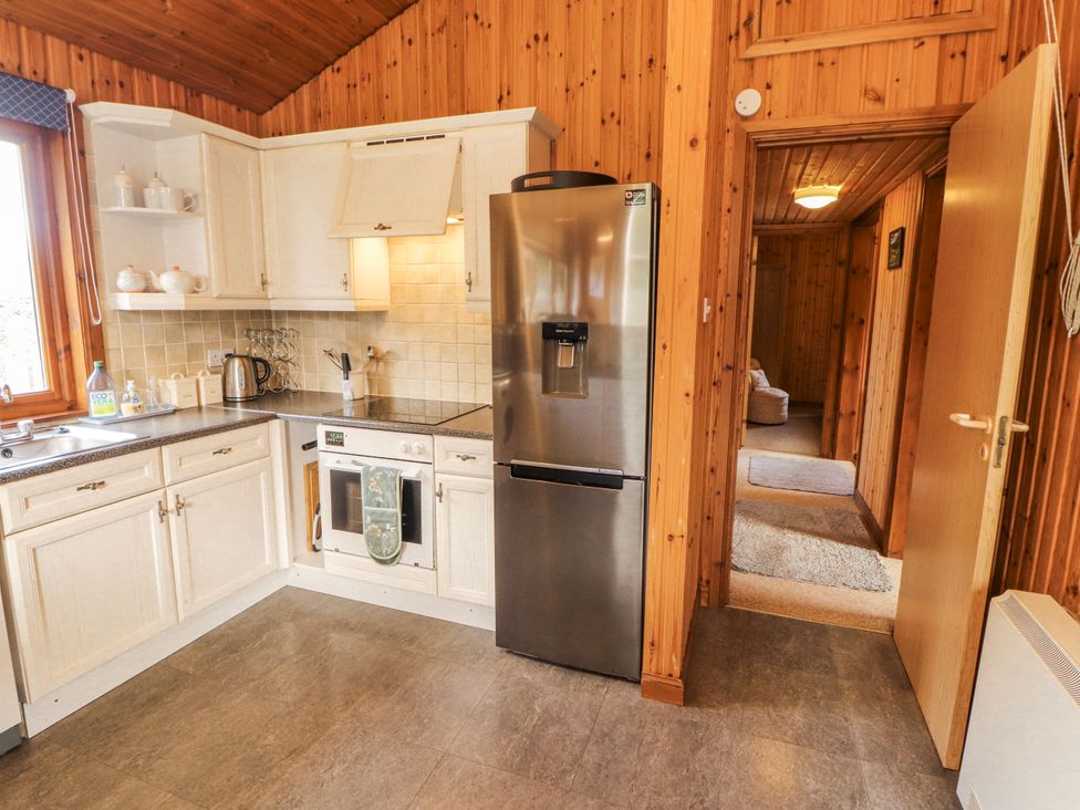 A kitchen with appliances and cabinets at 26 Dukes Meadow Greystoke near Penrith