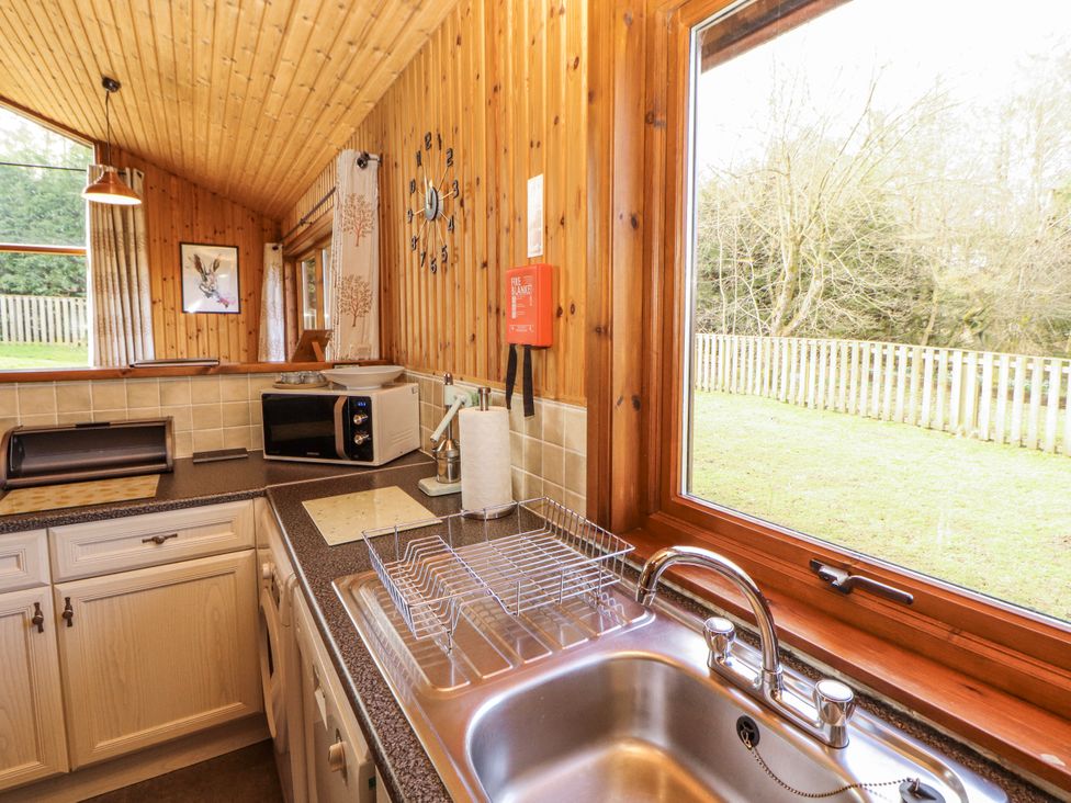 A kitchen with a sink and microwave at 26 Dukes Meadow Greystoke near Penrith