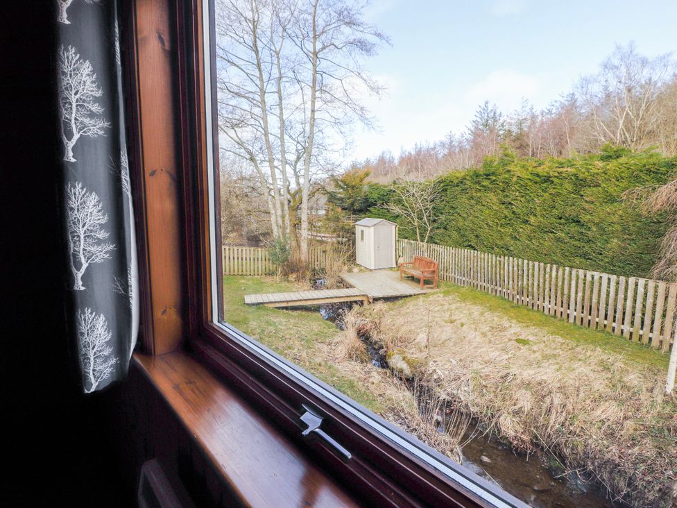 A view of a garden with a shed and bench at 26 Dukes Meadow in Greystoke near Penrith