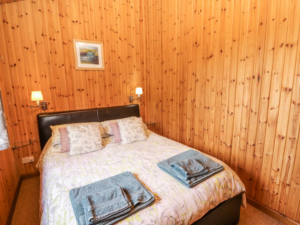 A bedroom with a bed and towels at 26 Dukes Meadow Greystoke near Penrith
