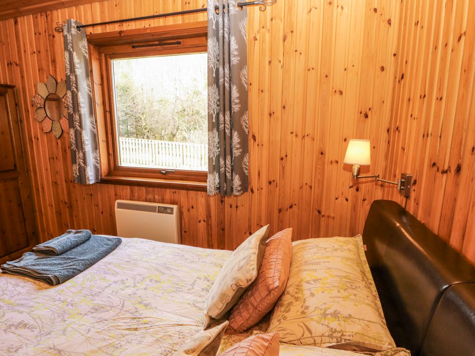 A bedroom with a bed and window at 26 Dukes Meadow in Greystoke near Penrith