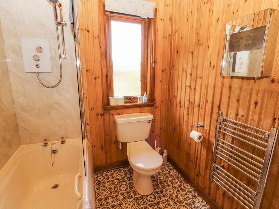 A bathroom with a shower, bathtub, and toilet at 26 Dukes Meadow Greystoke near Penrith
