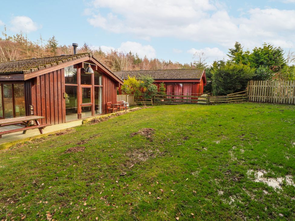 A garden with houses and grassy area at 26 Dukes Meadow in Greystoke near Penrith