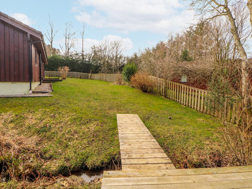 An outdoor area with a wooden bridge and grass at 26 Dukes Meadow Greystoke near Penrith