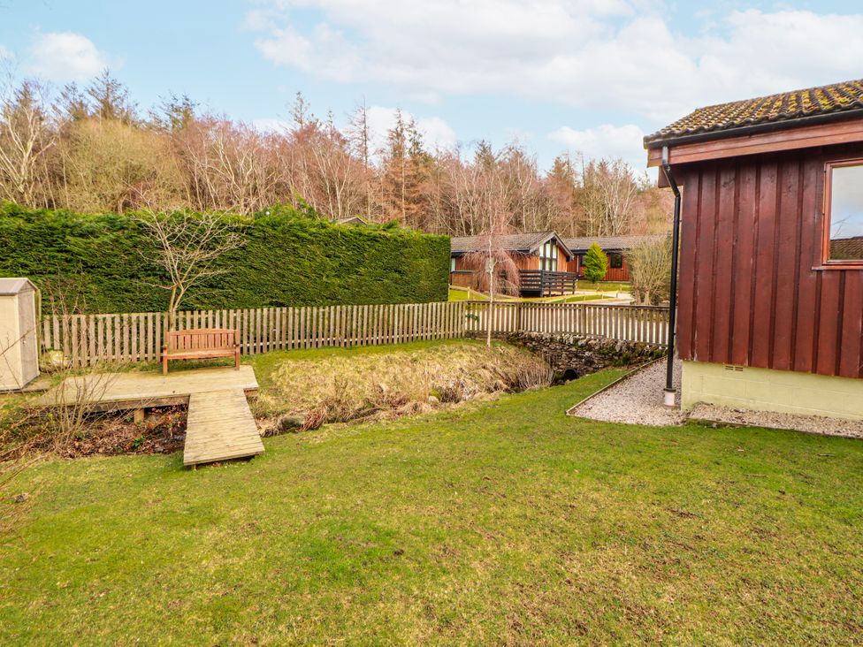 A garden area with a wooden bench and pathway at 26 Dukes Meadow Greystoke near Penrith