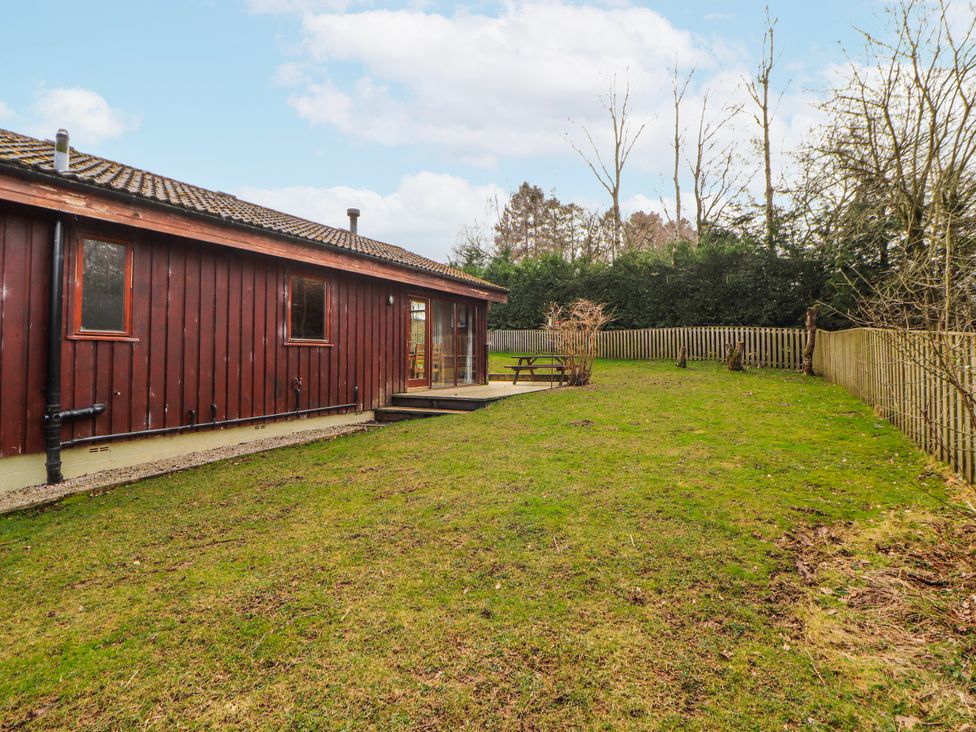 An outdoor area with a wooden building and picnic table at 26 Dukes Meadow Greystoke near Penrith