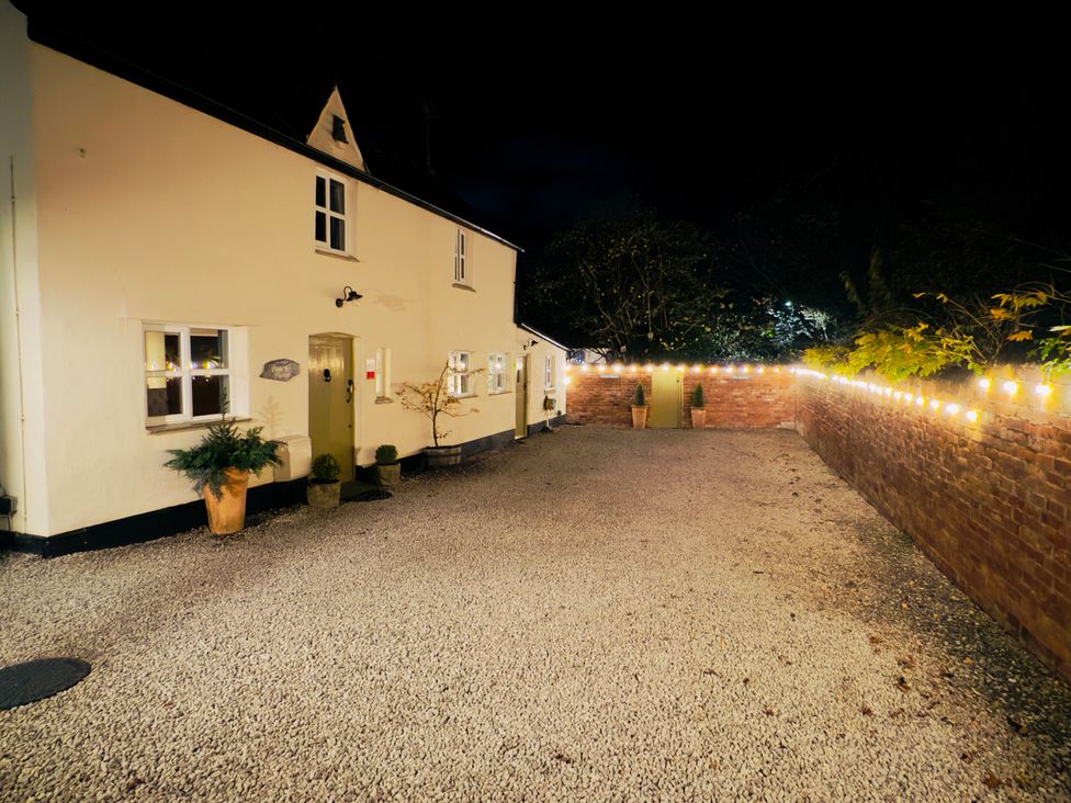 An outdoor area with a house, gravel, and garden lights at The Coach House in Prestatyn