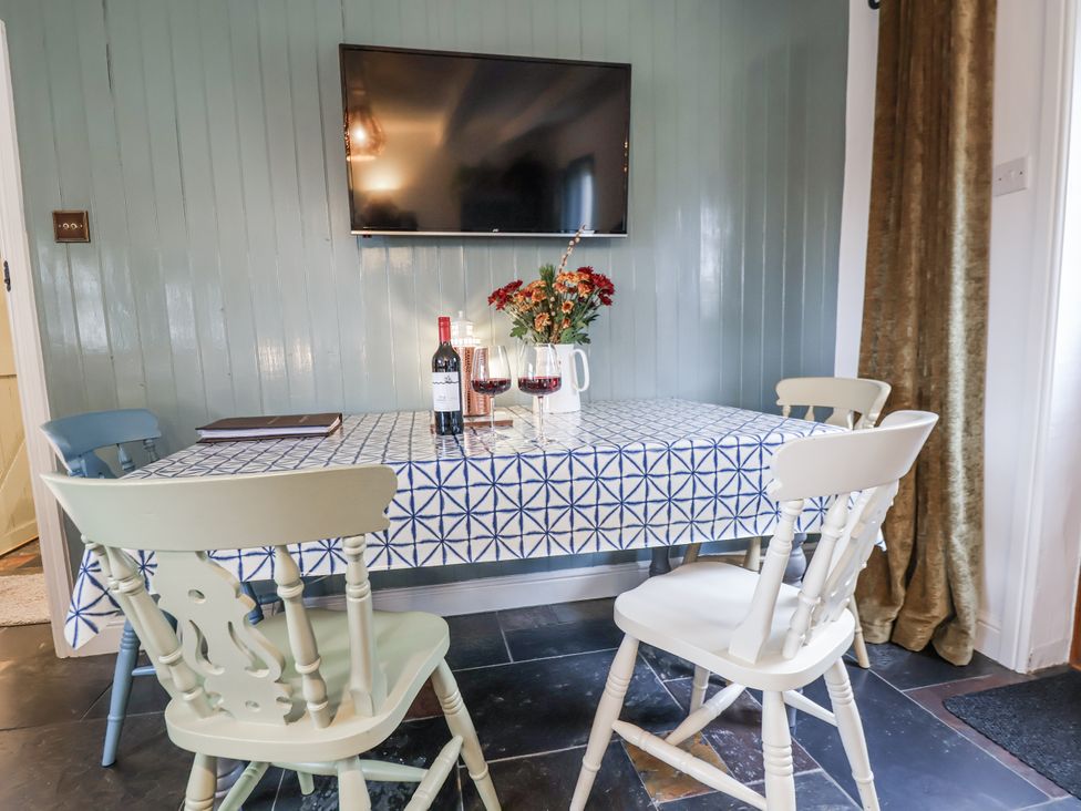 A dining room with a table and chairs at The Coach House in Prestatyn