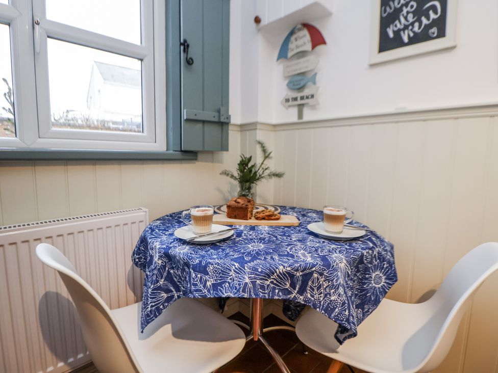 A dining room with a table set for two at The Coach House in Prestatyn
