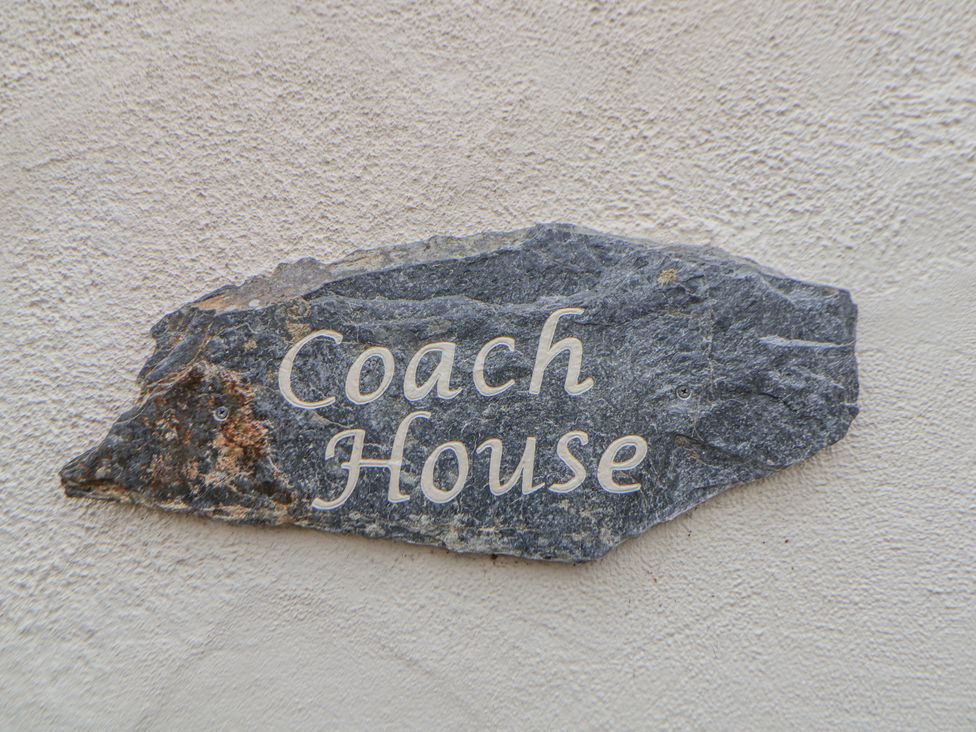 A stone sign that reads Coach House at The Coach House Prestatyn