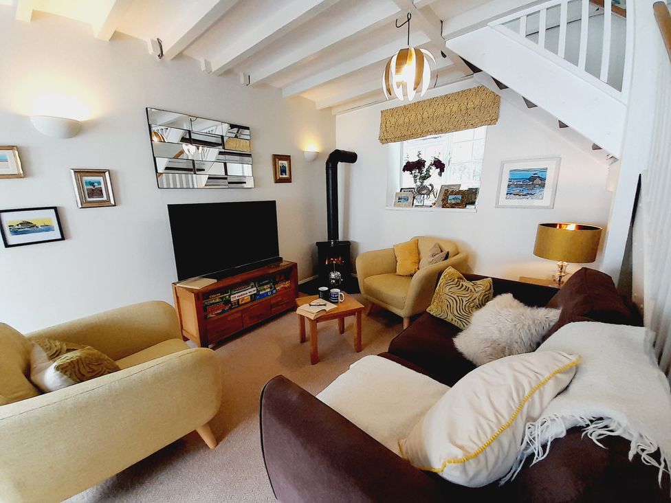 A living room with a television and sofa at Crab Cottage in Ilfracombe