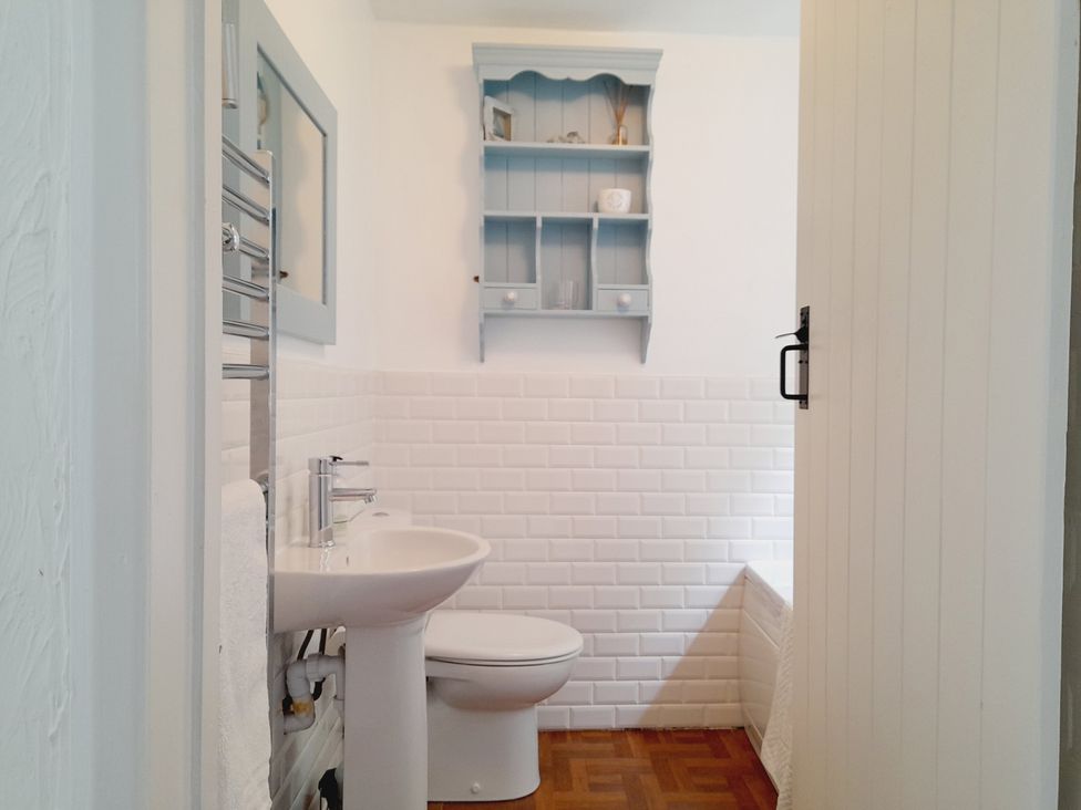 A bathroom with a sink and toilet at Crab Cottage in Ilfracombe