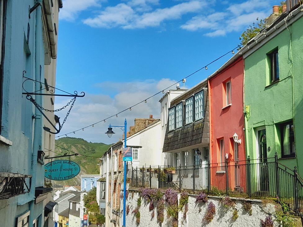 Houses along a street with a view of mountains at Crab Cottage Ilfracombe