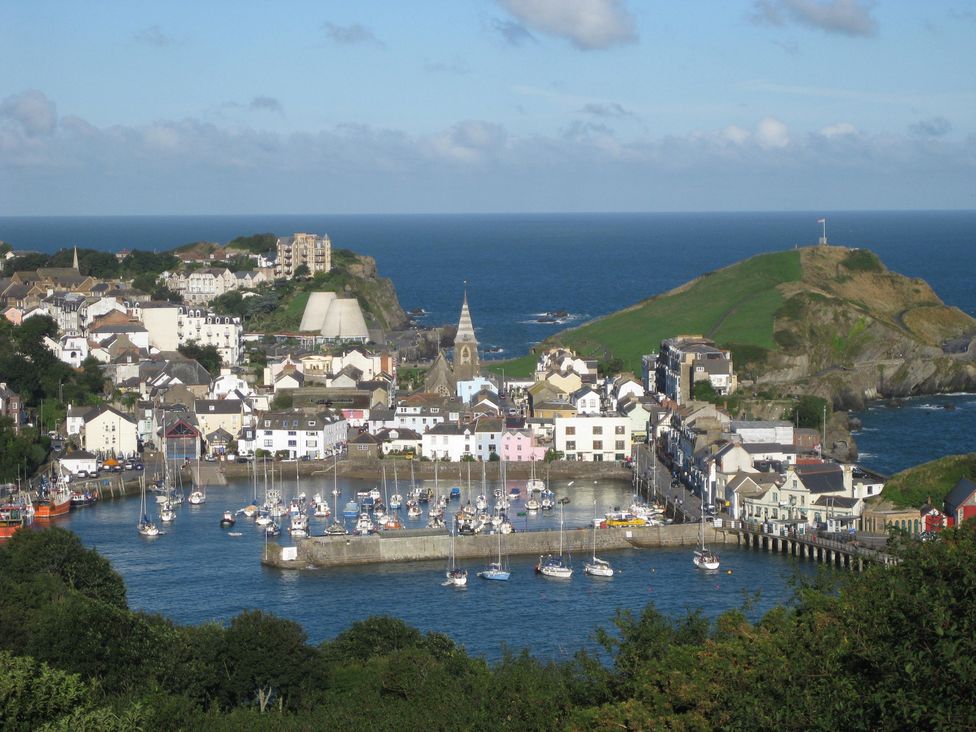 A harbor with boats and buildings at Crab Cottage in Ilfracombe