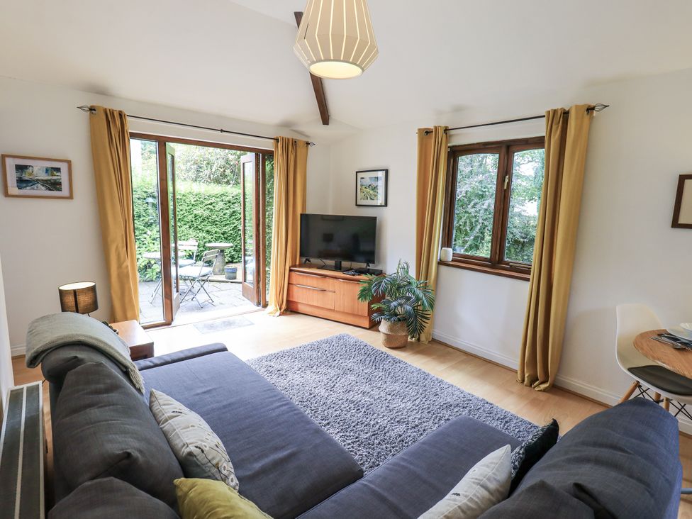 A living room with a sofa and television at Doe Foot Cottage Ingleton