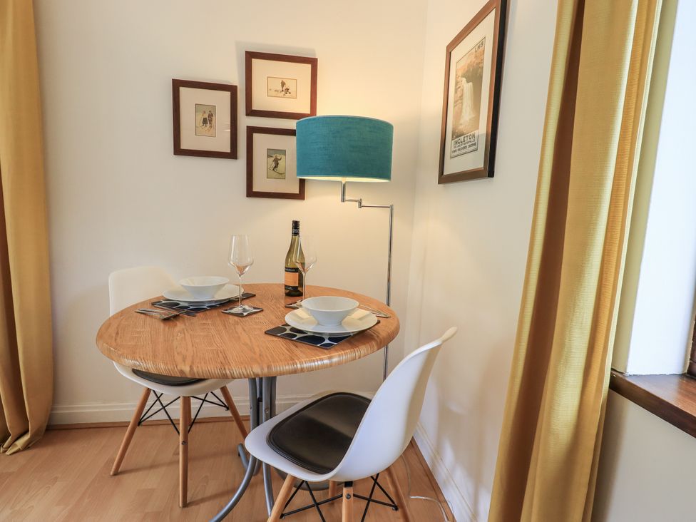 A dining room with a round table and two chairs at Doe Foot Cottage Ingleton