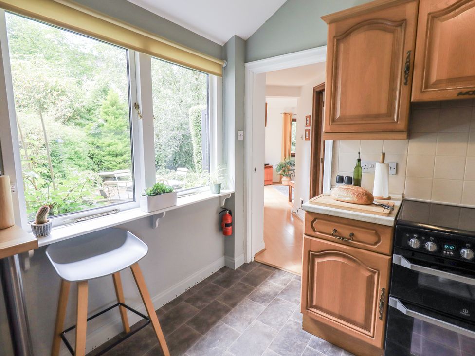 A kitchen with a window, countertop, and cooker at Doe Foot Cottage Ingleton