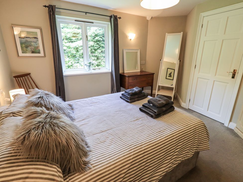 A bedroom with a bed and window at Doe Foot Cottage Ingleton