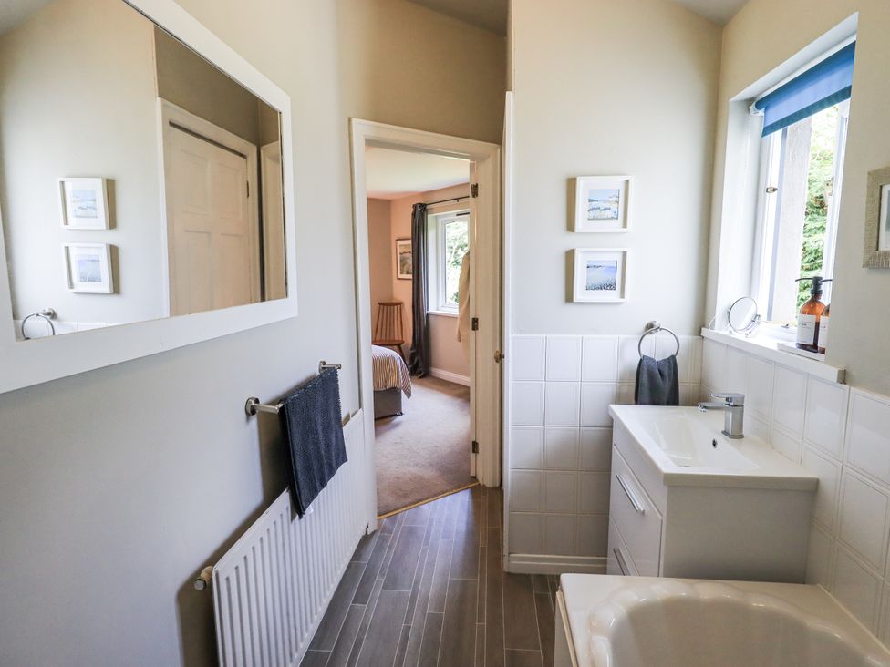 A bathroom with a sink and mirror at Doe Foot Cottage Ingleton