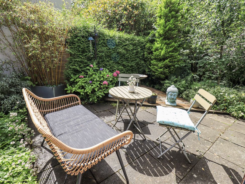 A garden with seating and greenery at Doe Foot Cottage Ingleton