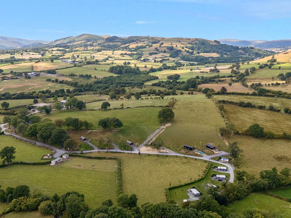 An aerial view of fields and hills at Hillside Lodge Nantmel near Rhayader