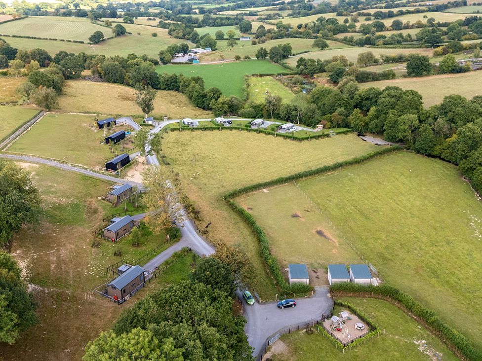 A view of cabins and fields at Hillside Lodge Nantmel near Rhayader