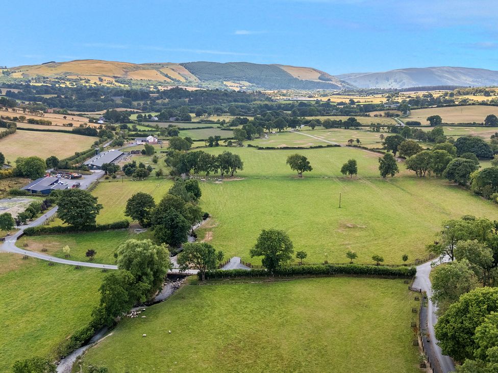 An aerial view of fields and trees at Hillside Lodge Nantmel near Rhayader