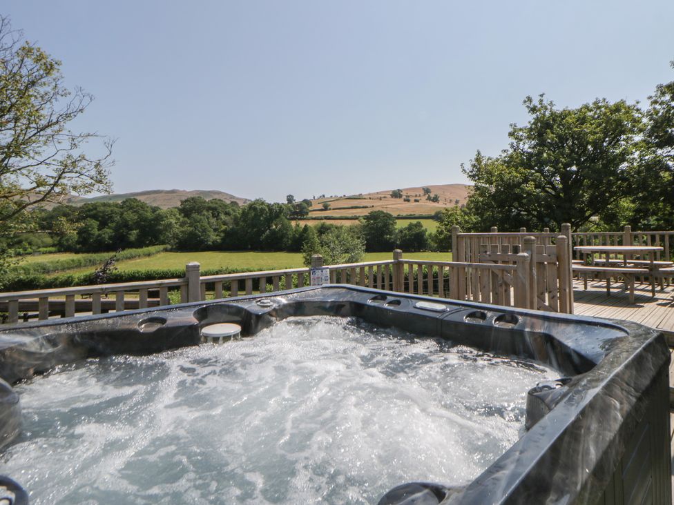 A hot tub in an outdoor area at Hillside Lodge in Nantmel near Rhayader