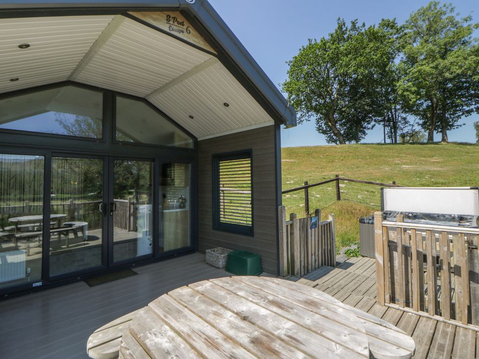 An outdoor space with a table and chairs at Hillside Lodge Nantmel near Rhayader