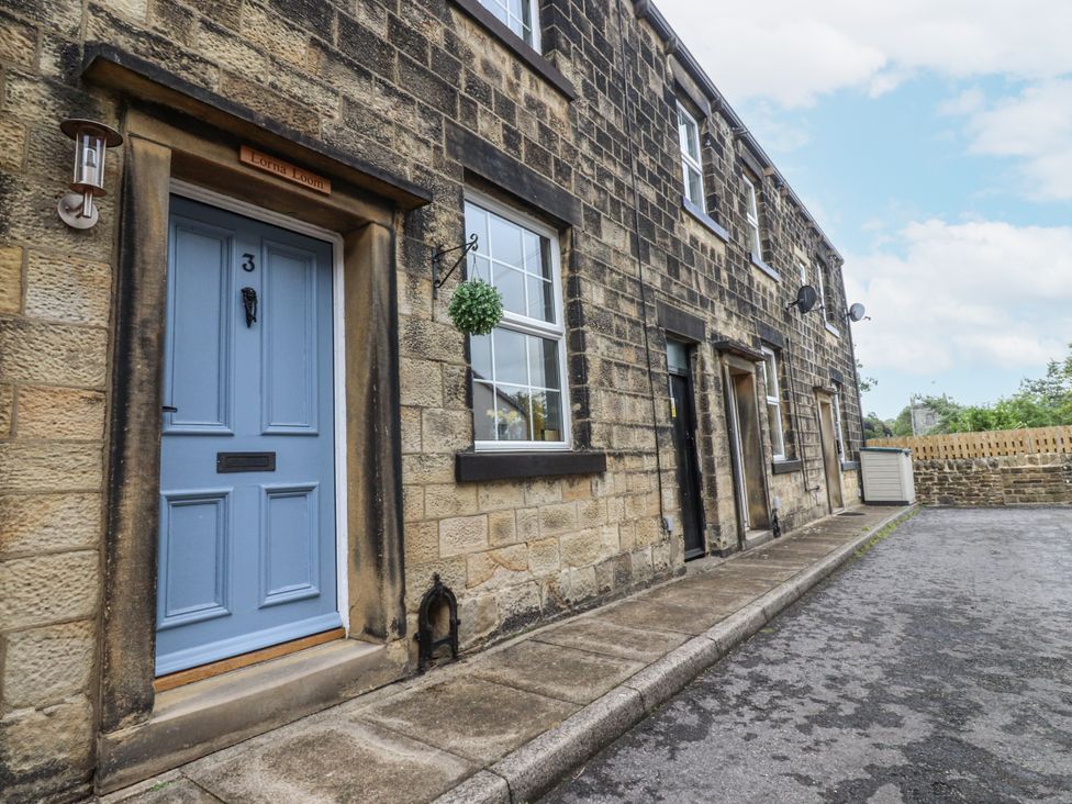 A blue door and windows on a stone house at Lorna Loom in Skipton
