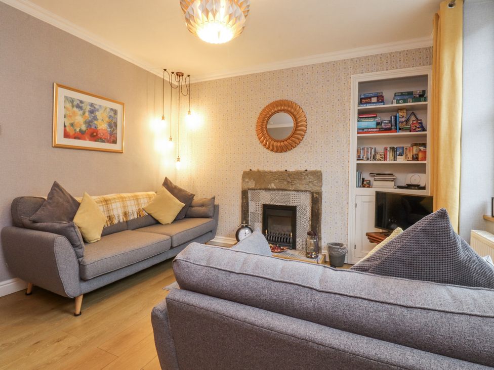 A living room with a sofa and fireplace at Lorna Loom in Skipton