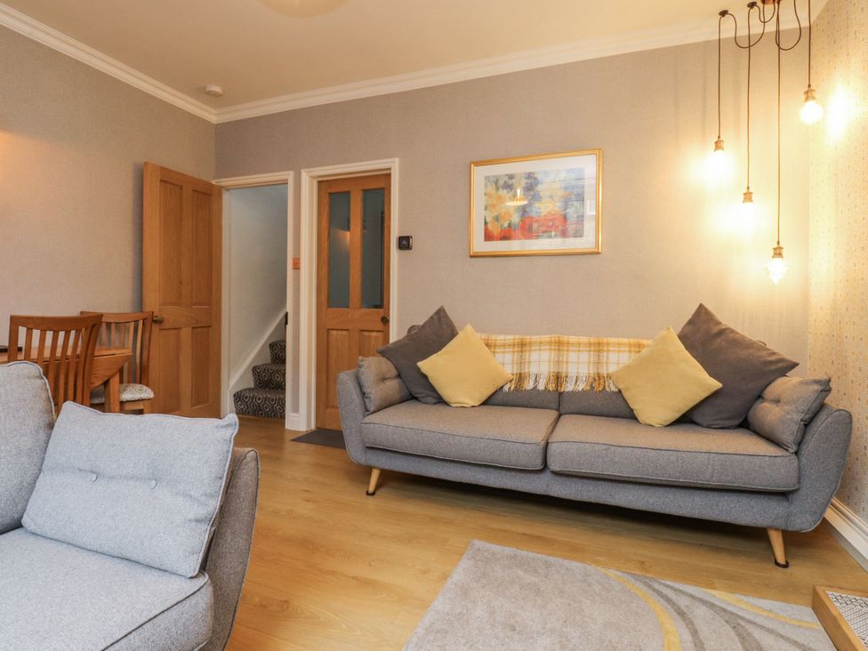 A living room with a sofa and dining area at Lorna Loom in Skipton