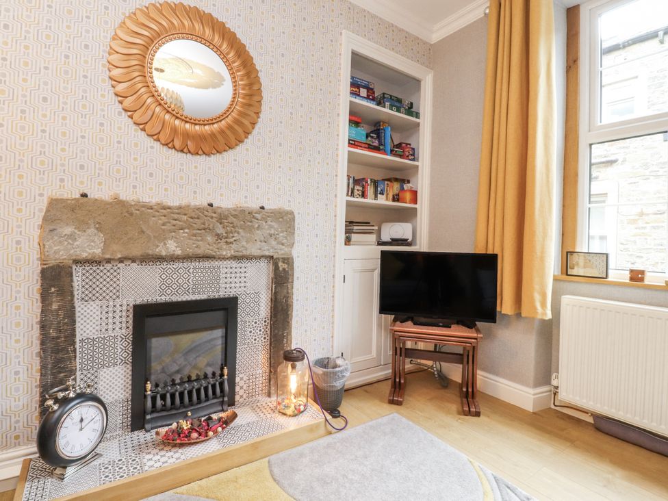 A living room with a fireplace and television at Lorna Loom in Skipton