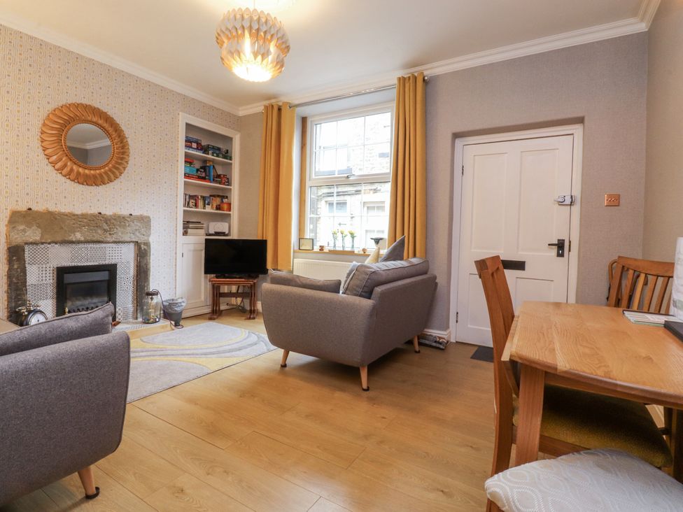 A living room with a sofa and dining table at Lorna Loom in Skipton