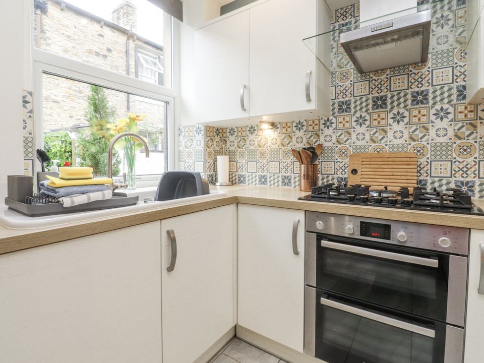 A kitchen with a sink and stove at Lorna Loom in Skipton