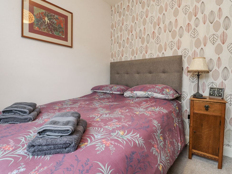 A bedroom with a bed and bedside table at Lorna Loom in Skipton