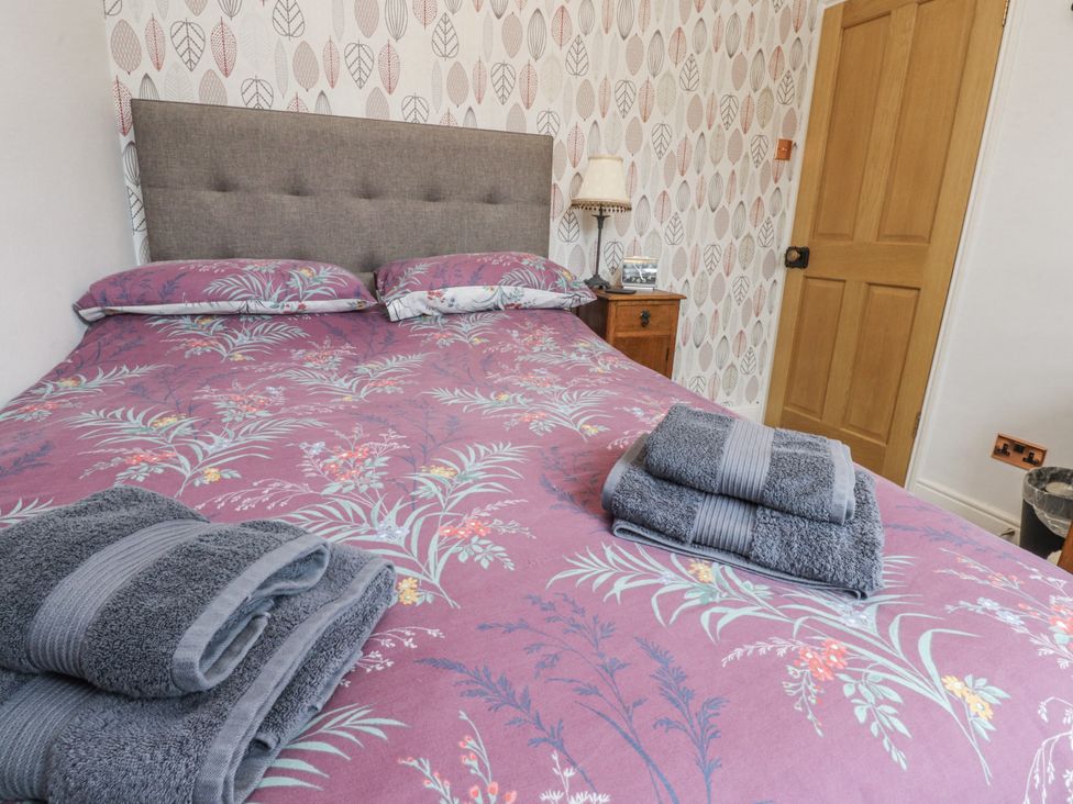 A bedroom with a bed and towels on top at Lorna Loom in Skipton