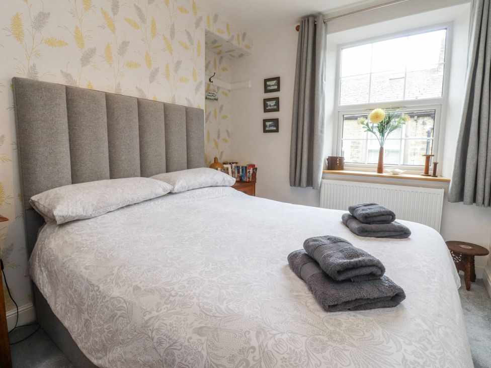 A bedroom with a bed and window at Lorna Loom in Skipton