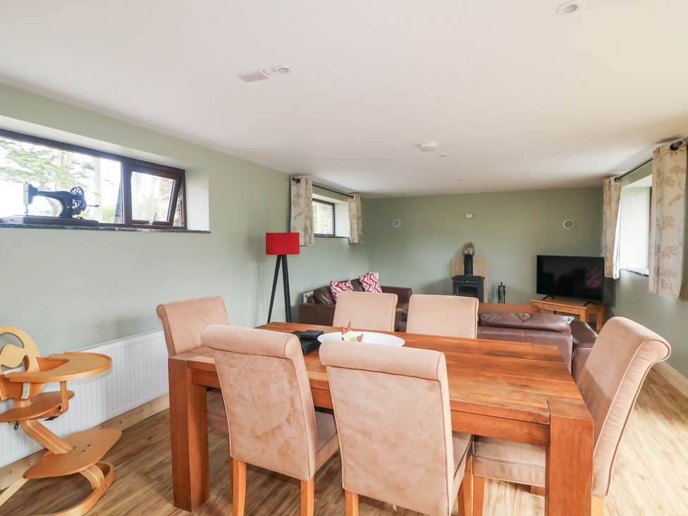 A dining room with a table and chairs at The Owl's Hoot in Tacumshane, County Wexford